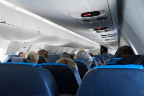 istock Interior inside of the plane with passengers. 1003420418