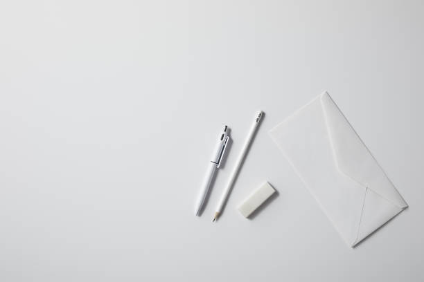 istock top view of envelope with pen and pencil on white surface for mockup 1003422826