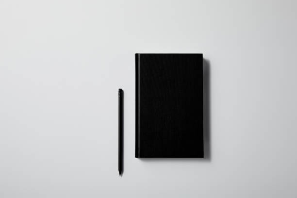 istock top view of black notebook with pencil on white surface for mockup 1003422840