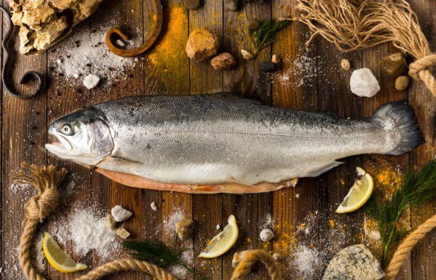 istock One fresh fish on gray boards. Top view. Daylight. 1003426304