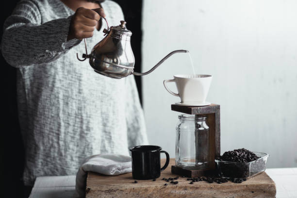 istock Coffee drip,Hand holding a kettle Drip Coffee In the room 1003427794