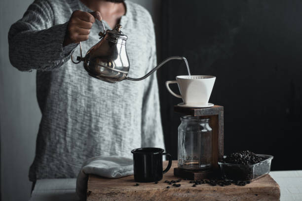 istock Coffee drip,Hand holding a kettle Drip Coffee In the room 1003427968