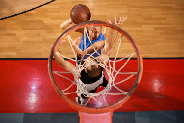 Two Friends Playing Basketball Basketball player makes slam dunk - Man Dunking