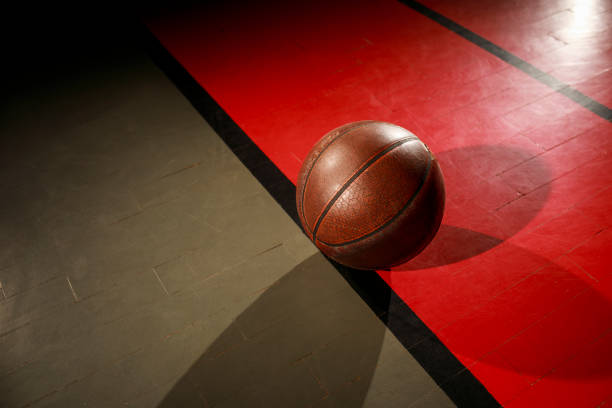 istock Basketball ball on court floor 1003436114