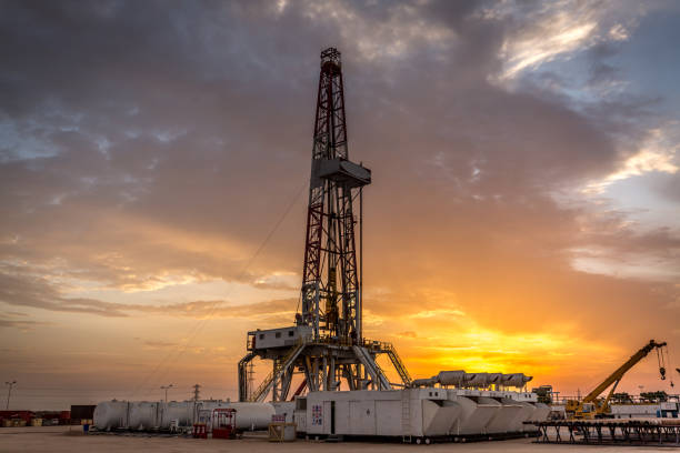 Fracking Drill Rig at Sunset Sunset, Construction Industry, Dawn, Single Line, Sunrise - Dawn wellhead stock pictures, royalty-free photos & images