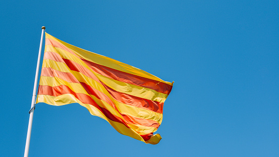 La Senyera, the red and yellow flag of Catalonia flying in Girona, Spain.