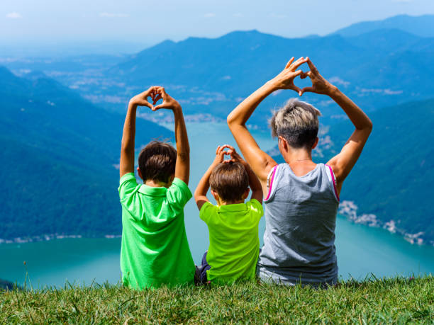 istock Mother in the meadow with her children 1003471718