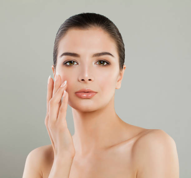 istock Spa Woman Touching her Hand her Face. Spa Model Portrait 1003474842
