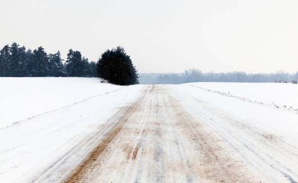 istock Road in winter weather. straight road 1003477098