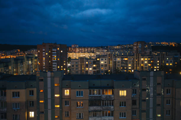 istock Aerial view of town with old socialist soviet panel building at night. 1003479624