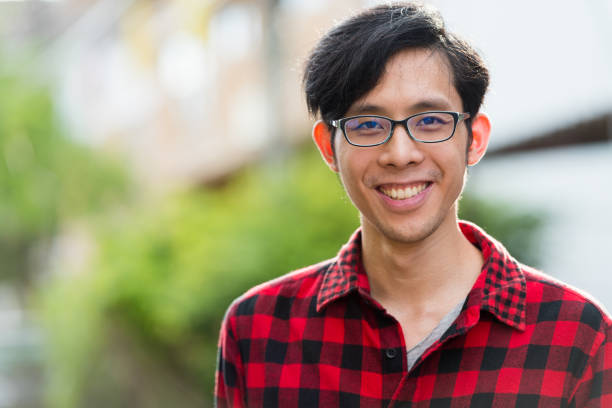 istock Young happy Asian man outdoors 1003483944