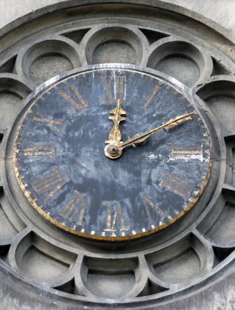 istock old weathered church tower clock surround with roman numerals and gold hands stopped at ten past twelve with fading paint 1003484708