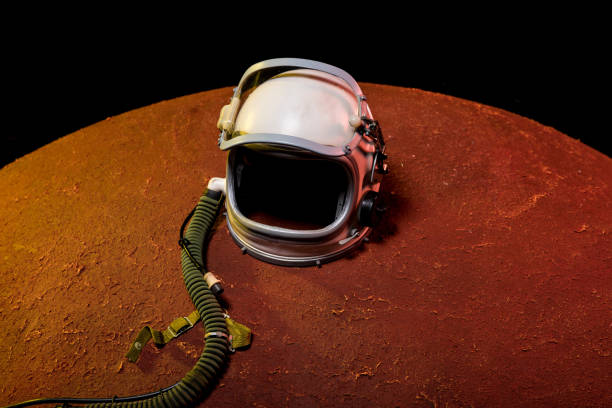 istock helmet from spacesuit lying on red planet in black cosmos 1003485472