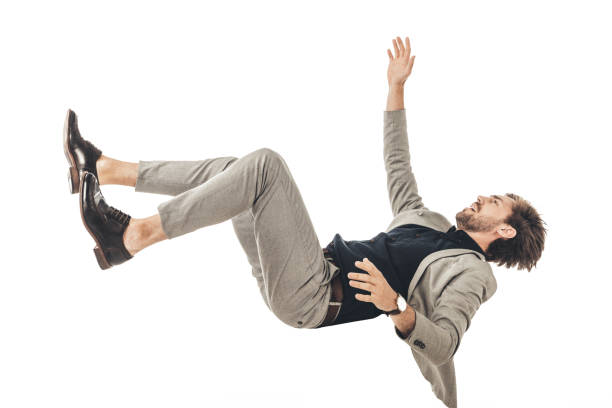 istock frightened young businessman in suit falling isolated on white 1003490532