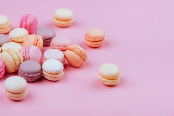 istock Different types of macaroons on pink background. 1003490558