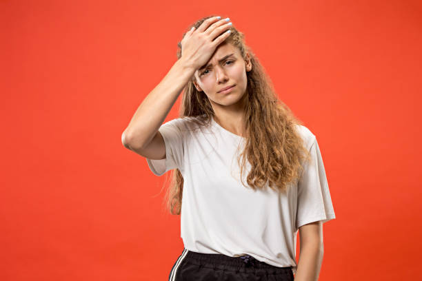 istock Woman having headache. Isolated over pastel background 1003490792