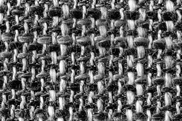 Texture of cloth material for design. Abstract background with white, black and gray threads of woven.