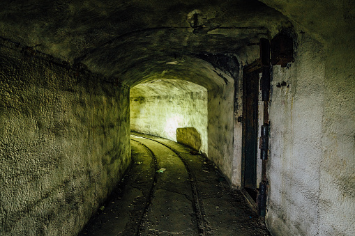 An abandoned warship ammunition transport tunnel with the remains of a narrow gauge railway under Sevastopol