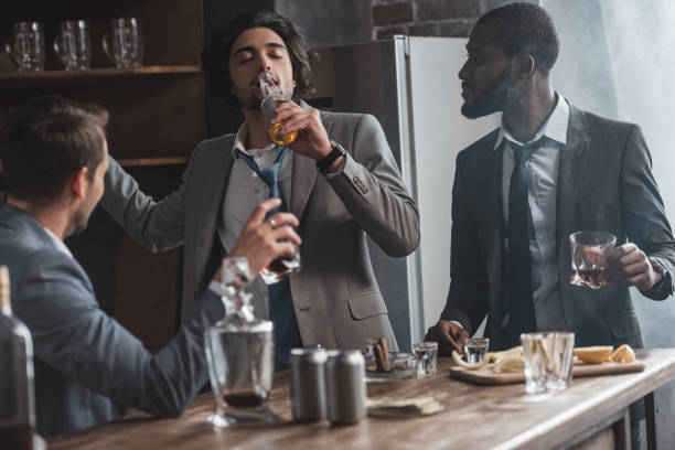 istock young multiethnic businesmen drinking alcohol beverages together 1003529706