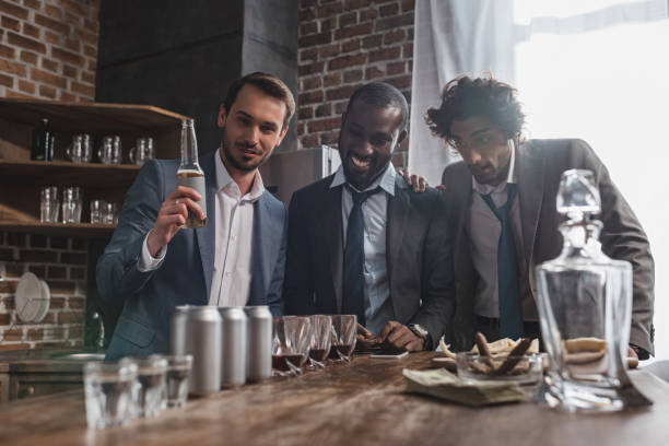 istock young multiethnic businessmen drinking alcohol beverages together 1003529750