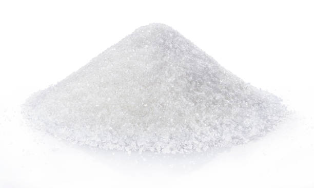 istock heap of white sugar isolated on white background. 1003535094