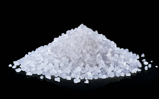 istock heap of salt isolated on black background. 1003535310