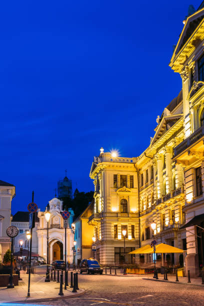 istock Vilnius Lithuania. Illuminated Lithuanian National Philharmonic Society, Basilian Gate, Motion Blur 1003538768