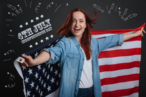 istock Positive American citizen holdign a national flag 1003539678