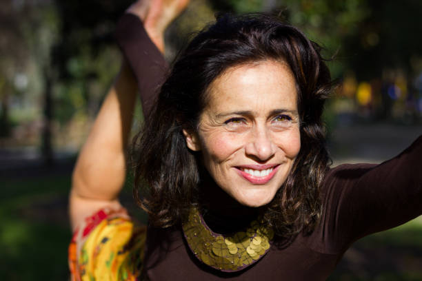 istock Gorgeous smiling lady practices yoga at the park 1003541802