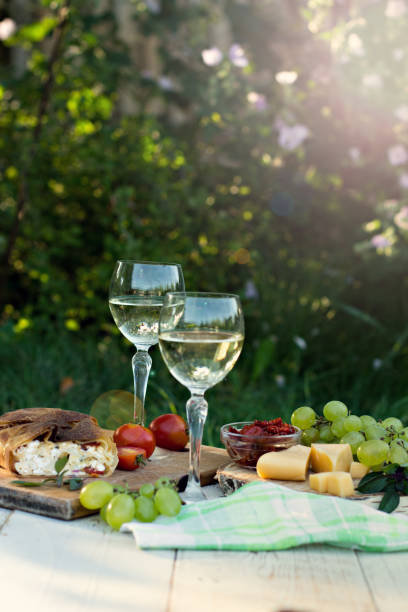 istock White wine and light snacks, Grapes, wine, cheese, pie. 1003542024