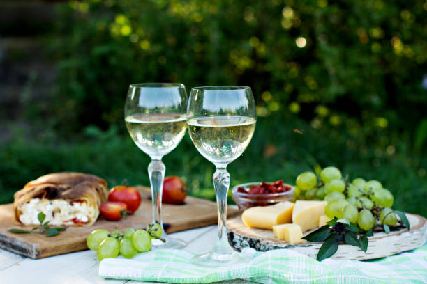 istock White wine and light snacks, Grapes, wine, cheese, pie. 1003542426