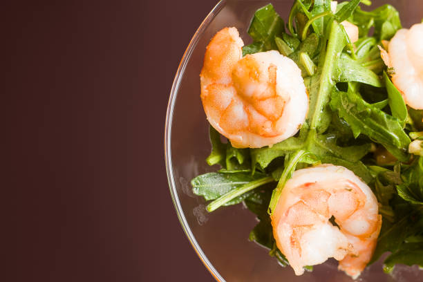 istock salad from arugula, shrimps, pine nuts, in a glass costs on a ta 1003542682
