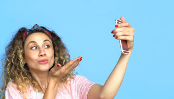 istock Woman is using Mobile Phone - Social Network Concept - Blue background 1003545662