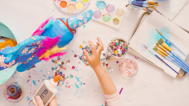 istock Decorating painted paper mache unicorn 1003550876