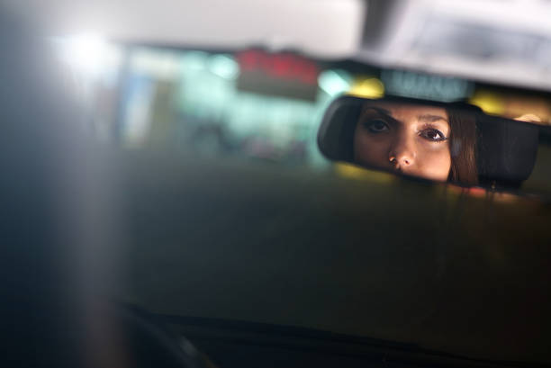 istock Woman Reflecting in Car Back Mirror 1003555448
