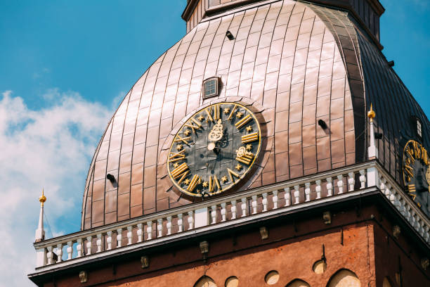 istock Clock On Tower Of Riga Dome Cathedral In Riga, Latvia. Sunny Sunset Blue Sky Background. 1003561296