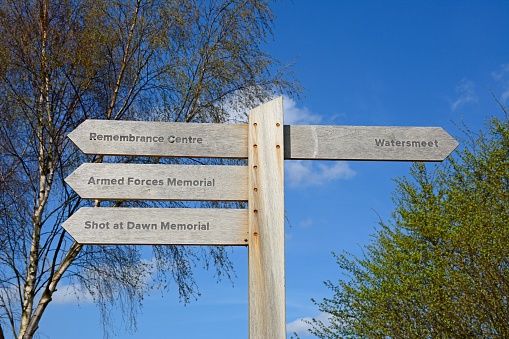 Wooden memorials fingerpost sign at the National Memorial Arboretum, Alrewas, Staffordshire, England, UK, Western Europe.