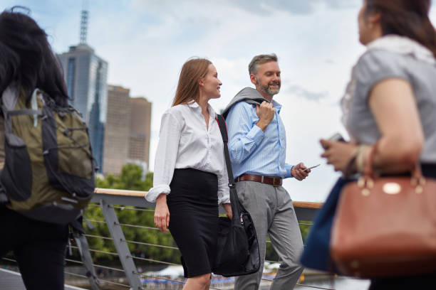 istock Executives talking and walking on bridge in city 1003562298