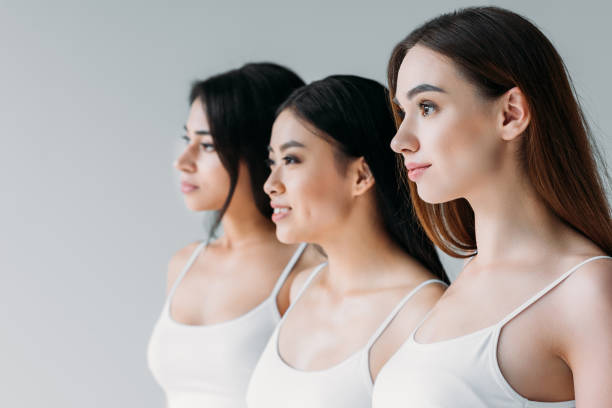 istock charming multiethnic girls looking away, isolated on grey 1003566398