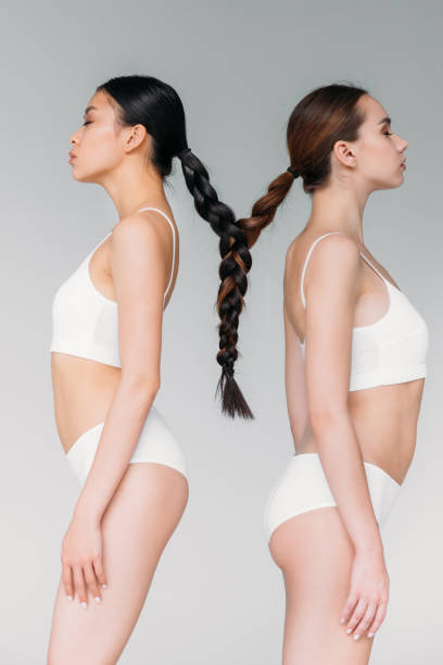istock elegant attractive multicultural girls with hair in one braid, isolated on grey 1003568498