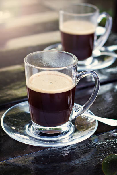 two espresso cups on a dark wooden table. Morning coffee.