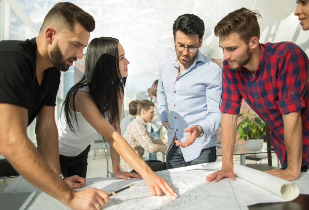 istock architect discusses the project with the business team 1003578176