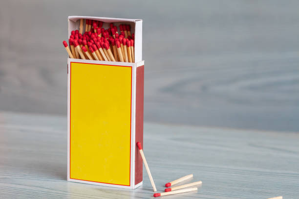 istock Matchstick out of matchbox on color wood table. 1003578896