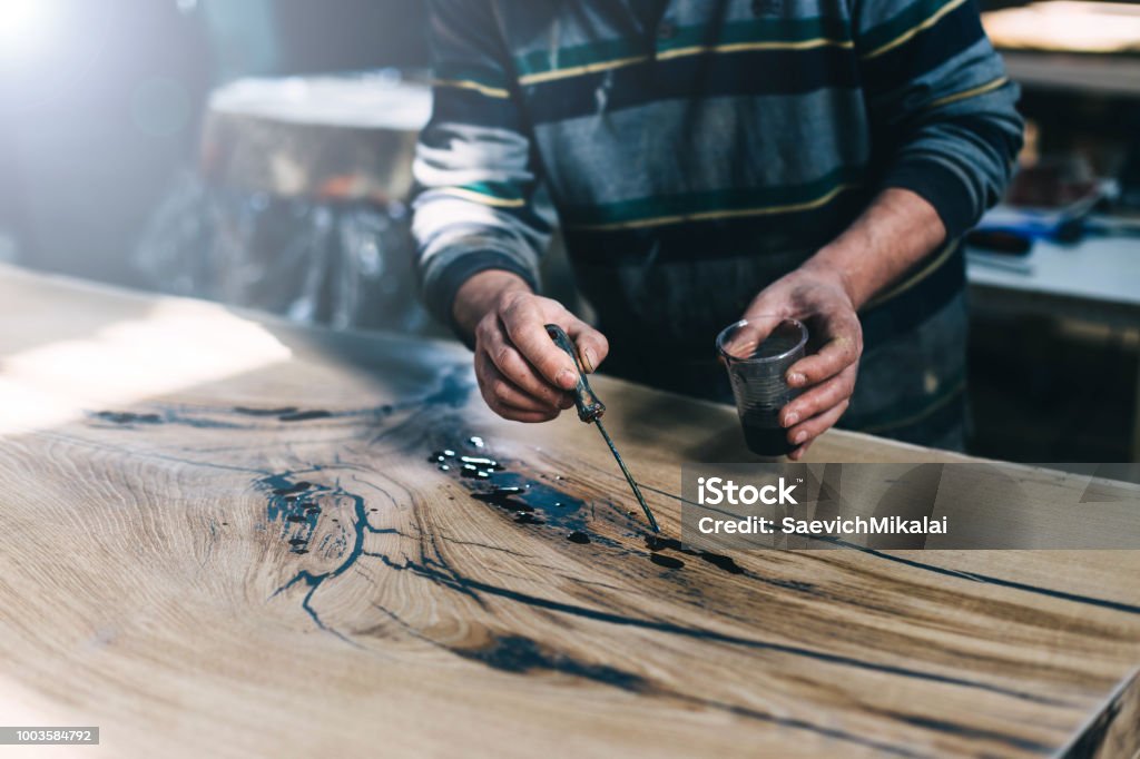 Manufacture Of Furniture From Solid Wood Treatment Of A Wooden Table With  Varnish Epoxy Resin Paint Handmade Stock Photo - Download Image Now - iStock
