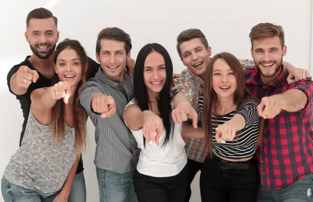 istock fun team of young people pointing at you 1003588260
