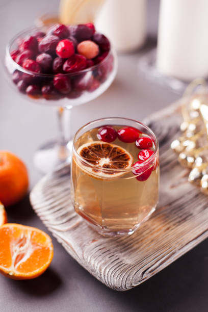 christmas hot apple cider with cinnamon, cranberry and orange on a wooden tray - raspberry table wood autumn imagens e fotografias de stock