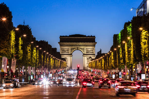 Avenue des Champs Elysees and Arc de Triomphe at night. Paris, France Paris, France - June 25, 2017: The Avenue des Champs Elysees and Arc de Triomphe (Arch of Triumph of the Star) in the summer at night. arc de triomphe paris stock pictures, royalty-free photos & images