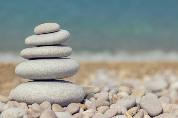istock Grey pebbles: stone cairn tower, poise stones,  zen sculpture 1003589406