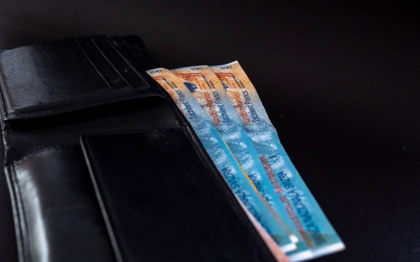 istock hundred swiss francs in a purse on a black surface 1003592426
