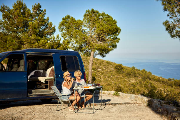 istock Man and woman resting after road trip on mountain 1003593054